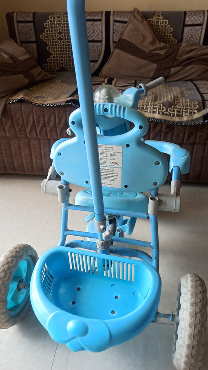 Musical Tricycle with Parental Handle, Storage Basket, Music and Lights, Safety Harness for Kids, and Capacity Upto 20 kg (1 to 4 Years, Blue)